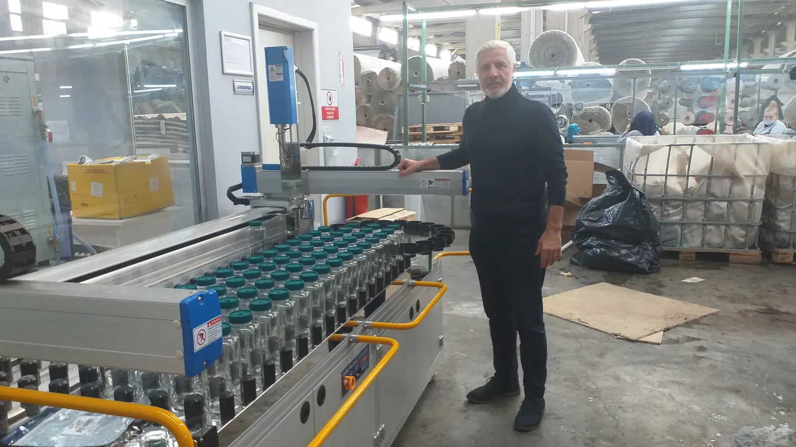 The Argetek team at a textile facility, next to the Color Focus-3 automatic pipetting system